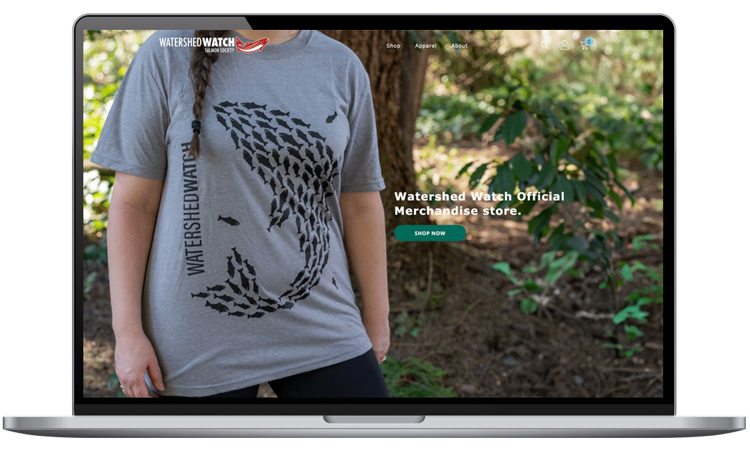 macbook-pro-shopify-Watershed-Watch-Shop | Joty Dosanjh Designs Mockup preview of the homepage of Watershed Watch Salmon Society merch shopify website